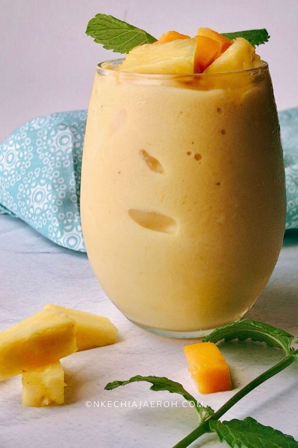 Healthy and nutritious mango pineapple smoothie recipe is refreshing and perfect for those hot days! We call it "nice cream" around here, and the kids love it! This creamy tropical smoothie deliciousness can easily replace your ice cream.  To make this vegan mango pineapple smoothie, you will need only five ingredients and a high-speed blender. A thick smoothie by nature, but you can thin it out by adding more liquid. #Tropicalsmoothie #Mangosmoothie #summersmothie #Pineapplesmoothie #nicecream