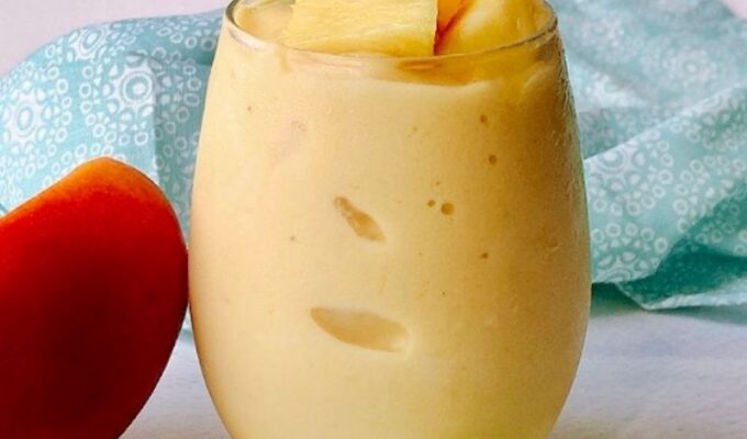Healthy and nutritious mango pineapple smoothie recipe is refreshing and perfect for those hot days! We call it "nice cream" around here, and the kids love it! This creamy tropical smoothie deliciousness can easily replace your ice cream. To make this vegan mango pineapple smoothie, you will need only five ingredients and a high-speed blender. A thick smoothie by nature, but you can thin it out by adding more liquid. #Tropicalsmoothie #Mangosmoothie #summersmothie #Pineapplesmoothie #nicecream