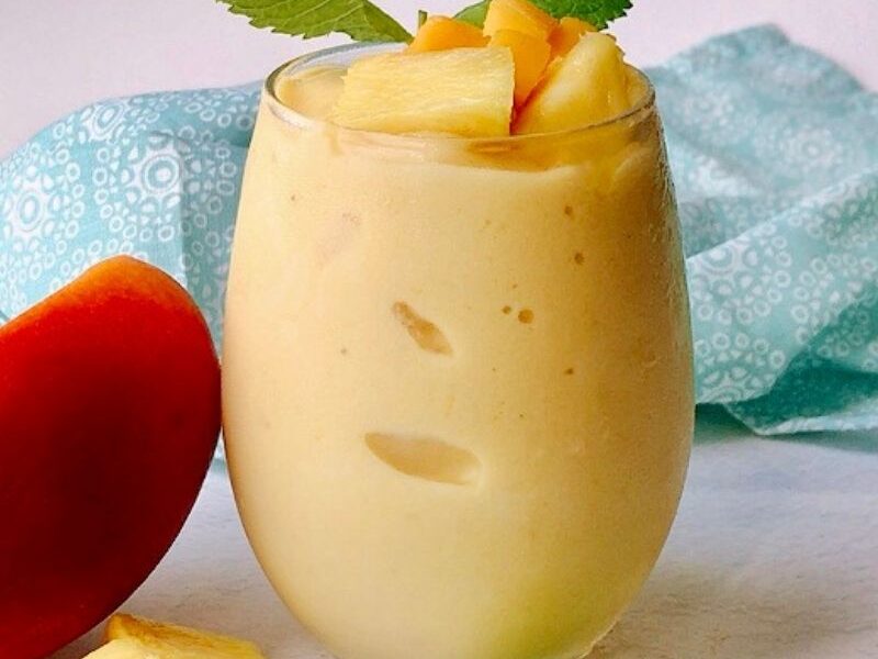 Healthy and nutritious mango pineapple smoothie recipe is refreshing and perfect for those hot days! We call it "nice cream" around here, and the kids love it! This creamy tropical smoothie deliciousness can easily replace your ice cream. To make this vegan mango pineapple smoothie, you will need only five ingredients and a high-speed blender. A thick smoothie by nature, but you can thin it out by adding more liquid. #Tropicalsmoothie #Mangosmoothie #summersmothie #Pineapplesmoothie #nicecream