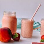 Healthy peach and strawberry is super easy to make, tasty, and refreshing! This nourishing breakfast smoothie is made with only five ingredients - frozen peaches, frozen strawberry, frozen, yogurt and orange juice! Though this is a vegetarian smoothie recipe, you can easily make it vegan by substituting Greek yogurt with a dairy-free yogurt. Smoothies are excellent no-cook foods during the summer heat (and beyond)! #Smoothies #breakfastsmoothie #healthysmoothie #peachsmoothie #strawberrysmoothie
