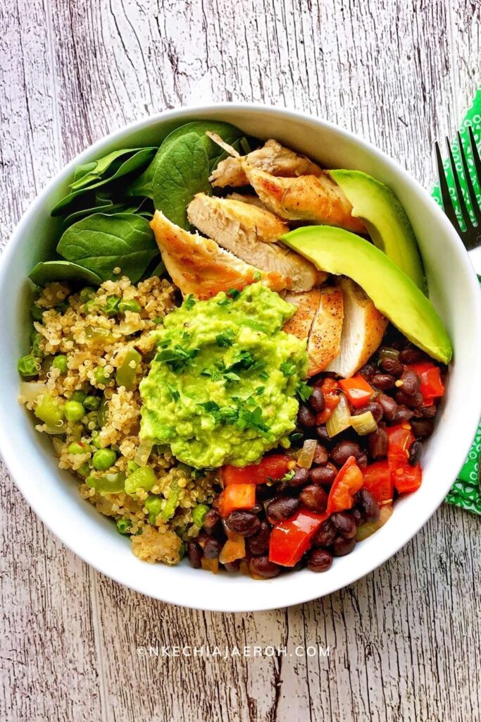 Nutrient-dense + tasty quinoa bowl recipe with black beans is literally the best thing E V E R! Listen, this is about to be your favorite quinoa bowl from now on (I AM NOT KIDDING)! Already cooked quinoa is deliciously sauteed with onions, bell peppers, mixed veggies, and spices. Sauteed black beans, chicken breast, mashed avocado, and fresh baby spinach completes this healthy quinoa bowl recipe! Finally, top this bowl with chopped fresh parsley and avocado slices and enjoy! #quinoarecipe #quinoabowl #blackbeanrecipe #quinoablackbeans #tacobowl