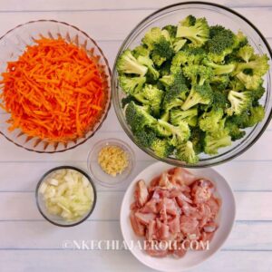 cut broccoli, shredded carrots, cut chicken, cut onions and grated garlic