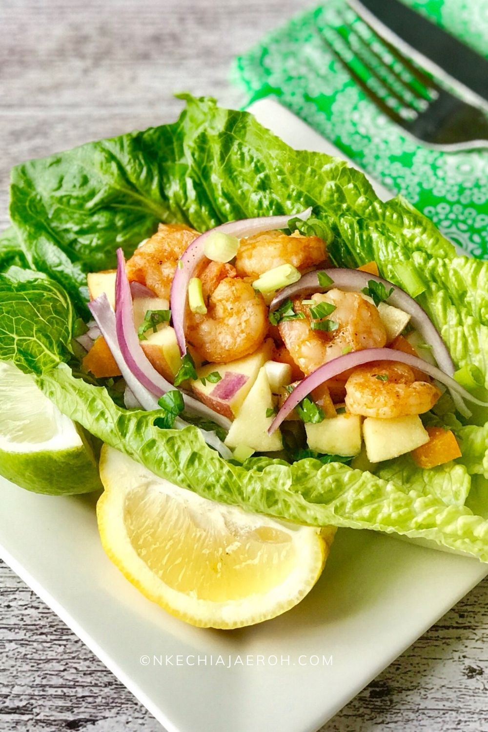 Healthy Spicy Shrimp Lettuce Wrap is low-carb, gluten-free, paleo-friendly, vegetarian, and super easy to make! This is an excellent alternative to regular taco, especially for light and clean eating. This 20-minute easy weekday lunch or dinner recipe is grain-free and served with healthy fuji apple salsa. You can substitute shrimp with tofu, or chicken; enjoy this healthy lettuce wrap recipe your way! #healthyrecipe #lettucewrap #apples #applerecipe #healthyshrimptaco #summertime #partyfood