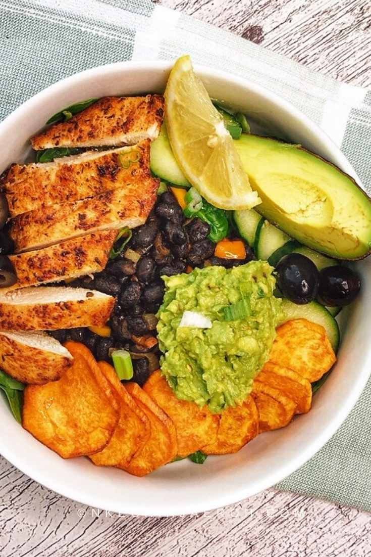 Deconstructed Taco Bowl Salad served with mashed avocado, olives, and vegetables