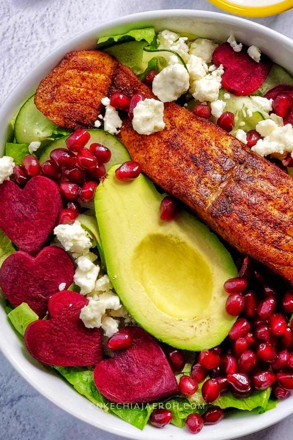 Easy to make raw beetroot and feta cheese salad with lettuce, cucumber, avocado, and salmon; serve with creamy yogurt dressing and top with your favorite things! I added pomegranate seeds, and it was perfect; the best part is that this recipe takes less than 15 minutes to put together. This heart-healthy beet salad is a dream!#Beet #beetroot #beetsalad #beetrootsalad #hearthealthysalad #beetsaladandfetacheese #beetrootandfetacheese #healthysaladrecipe