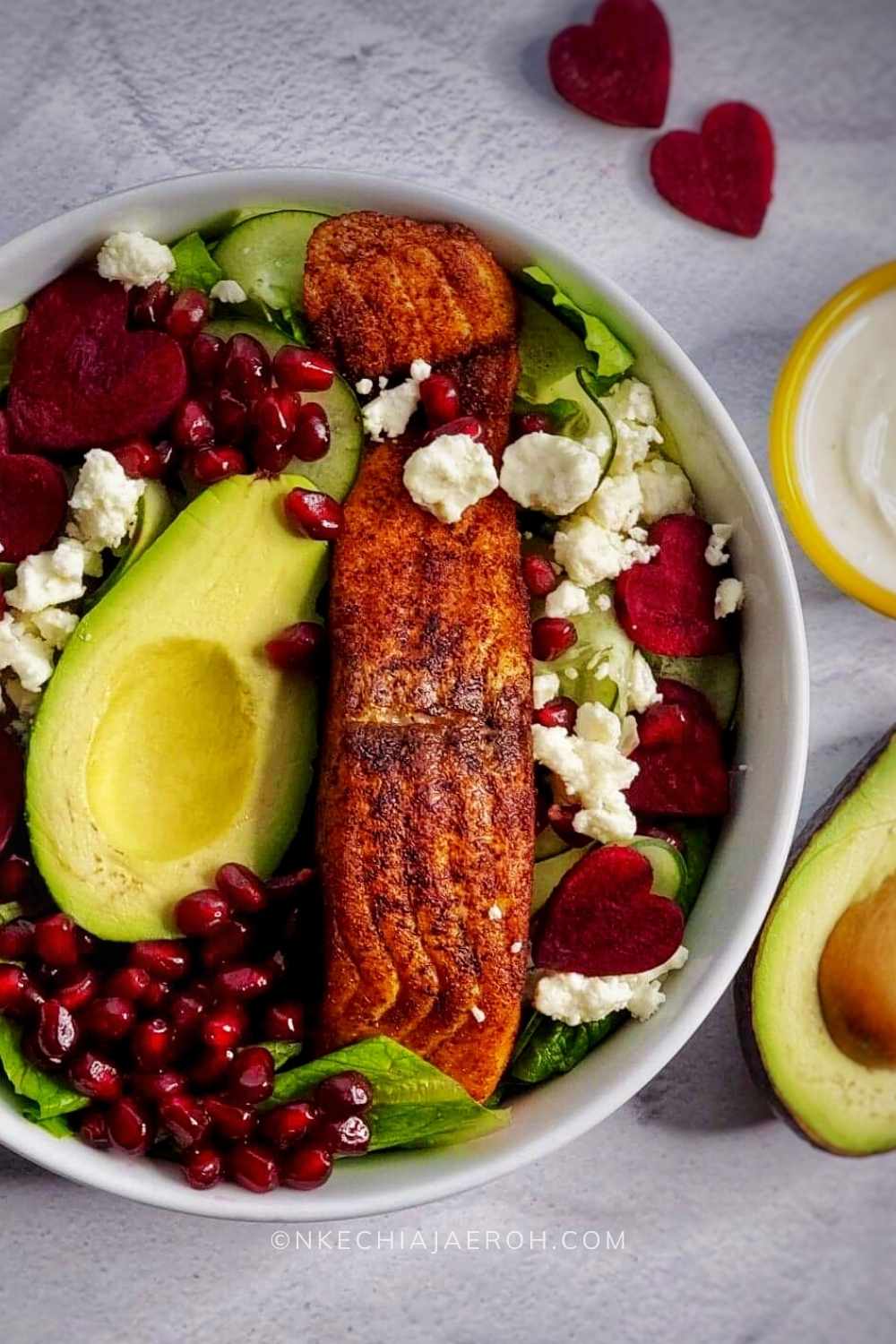 This salad is loaded with lettuce, cucumber, avocado, and salmon; serve with creamy yogurt dressing and top with your favorite things! I added pomegranate seeds, and it was perfect; the best part is that this recipe takes less than 15 minutes to put together. 