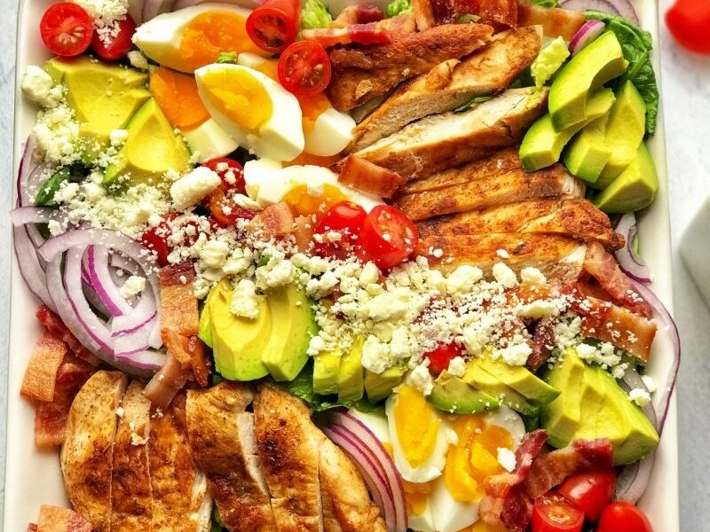 Healthy and delicious keto cobb salad is low-calorie (low-carb, obviously), gluten-free, very tasty, and full of flavors. This salad is made with fresh romaine lettuce, sautéed chicken breast, crispy bacon, hard-boiled eggs, cherry tomatoes, avocado, and crumbled feta cheese. The best thing about this cobb salad is it can be prepped ahead, which means it comes together quickly whenever you want to eat it! This is the low-carb meal prep salad recipe you are looking for; easy, breezy, and tasty! Definitely a must-try!
