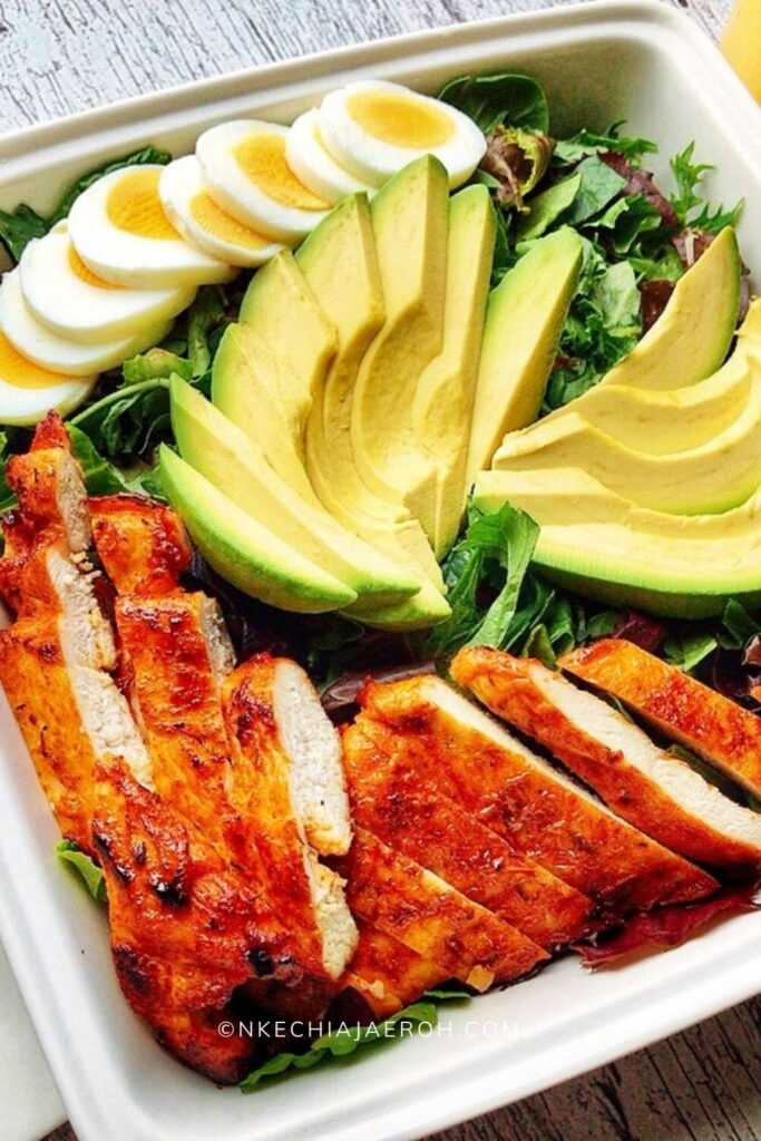 Spring mix salad with avocado, chicken breast and eggs