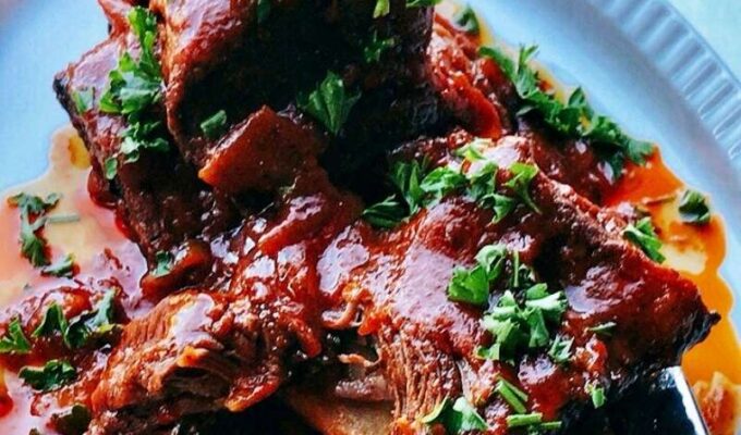 Mouthwatering and finger-licking good braised beef short ribs are flavorful, tender, tasty, juicy, and fall off the bone. I cooked these English – style short ribs without wine in the oven until they were very tender and juicy! Nothing makes more sense rather than braising well-seasoned and well-seared beef short ribs in sauce at low temperature for a long time. This way, they infuse and release tons of flavors, becoming very tender and juicy. Braised ribs are great for Sunday roast, Easter lunch, Thanksgiving dinner, or Christmas dinner. #Ribs #Braisedribs #BraisedBeefShortribs #roast #HolidayRecipe