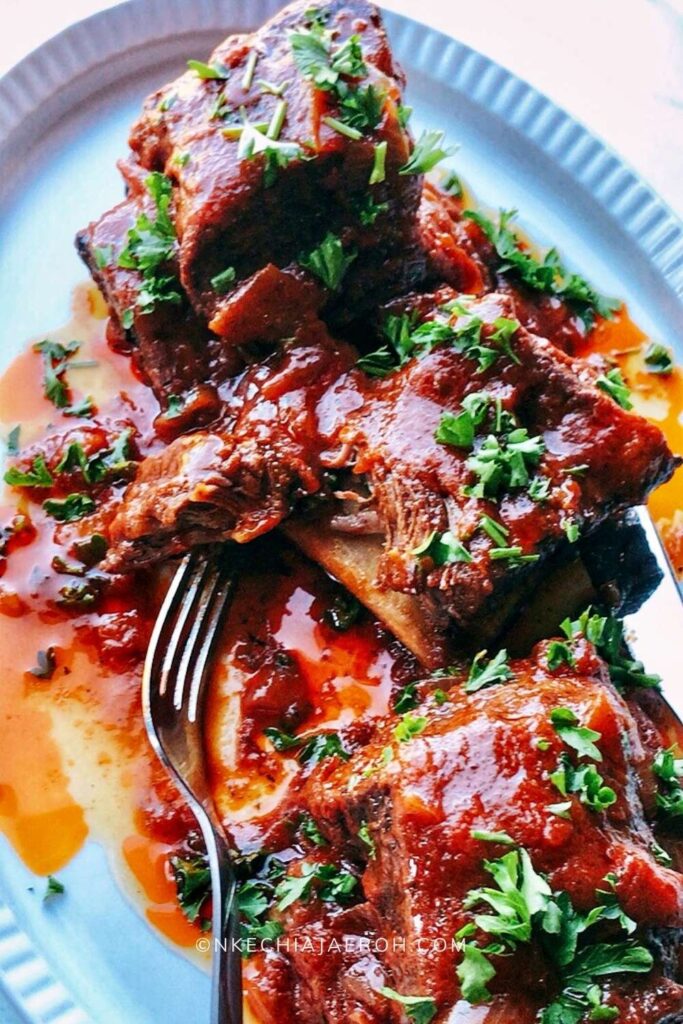 Mouthwatering and finger-licking good braised beef short ribs are flavorful, tender, tasty, juicy, and fall off the bone. I cooked these English – style short ribs without wine in the oven until they were very tender and juicy! Nothing makes more sense rather than braising well-seasoned and well-seared beef short ribs in sauce at low temperature for a long time. This way, they infuse and release tons of flavors, becoming very tender and juicy. Braised ribs are great for Sunday roast, Easter lunch, Thanksgiving dinner, or Christmas dinner. #Ribs #Braisedribs #BraisedBeefShortribs #roast #HolidayRecipe