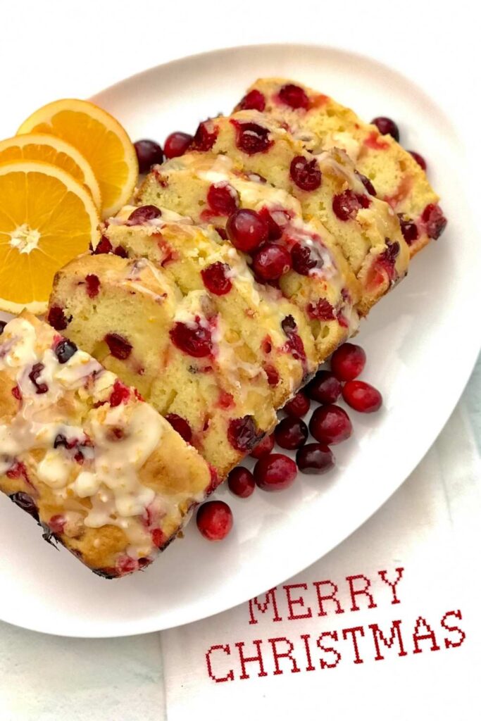 Easy cranberry orange bread with orange glaze is moist, tasty, flavorful, and sharp. It has the right amount of tart from the fresh cranberries, the sweetness of the orange juice, and flavors from the zest. Cranberry loaf bread is perfect for dessert, breakfast, or brunch! Easy cranberry bread is surely the way to go during the holidays! #Cranberries #cranberryseason #holidaybaking #Cranberrybread #orangebread #cranberryorangebread #Christmasdessert