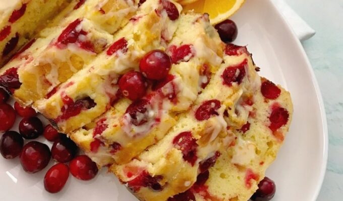 Easy cranberry orange bread with orange glaze is moist, tasty, flavorful, colorful and sharp. It has the right amount of tart from the fresh cranberries, the sweetness of the orange juice, and flavors from the zest. Cranberry loaf bread is perfect for dessert, breakfast, or brunch! Easy cranberry bread is surely the way to go during the holidays! #Cranberries #cranberryseason #holidaybaking #Cranberrybread #orangebread #cranberryorangebread #Christmasdessert