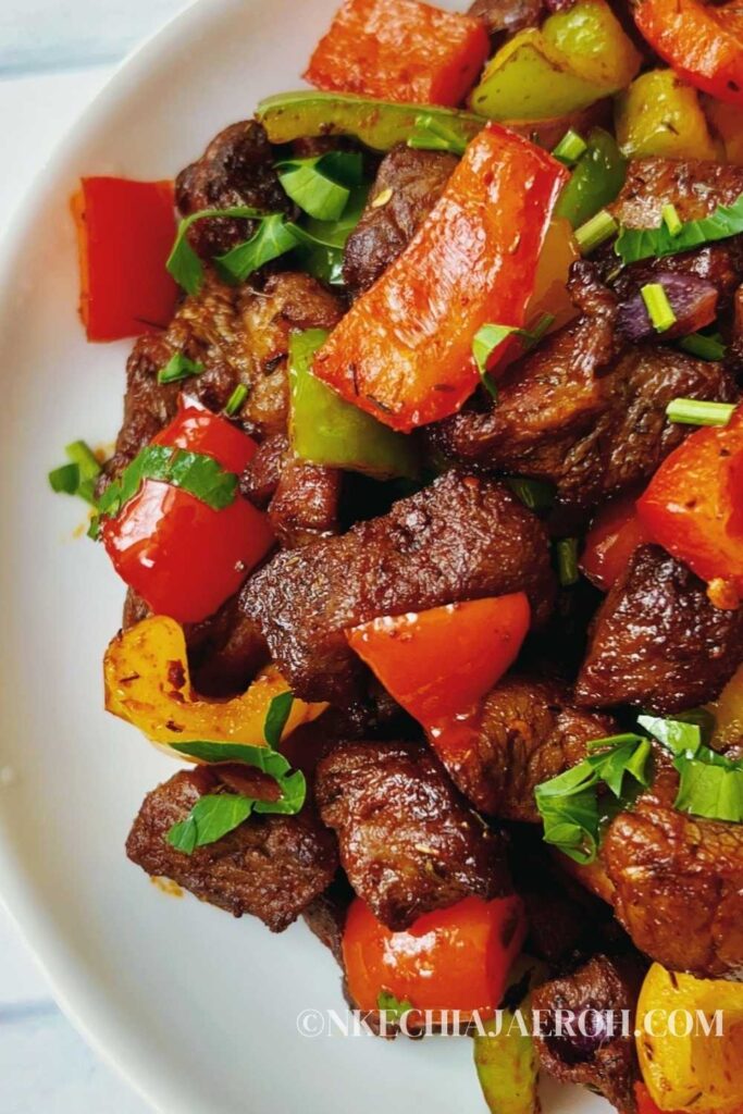 A simple recipe of steak bites in an air fryer with bell peppers, onions, herbs, spices, and cooks in less than 15 minutes is the satisfying pick-me-up dish you want on your table today! Air-fried steak bites and peppers are tasty, flavorful, colorful, scrumptious, crispy, shiny, juicy, and just finger-licking good! These steak bites are equally keto, gluten-free, whole30, and sugar-free. Cooking pepper steak, aka steak bites or beef tips, is easy and comes through quickly in an air fryer. I hope you can give these air fryer steak bites a try! #Steakbites #Steak #Peppersteak #Steakrecipe #beefbites #Beeftips #airfryersteak