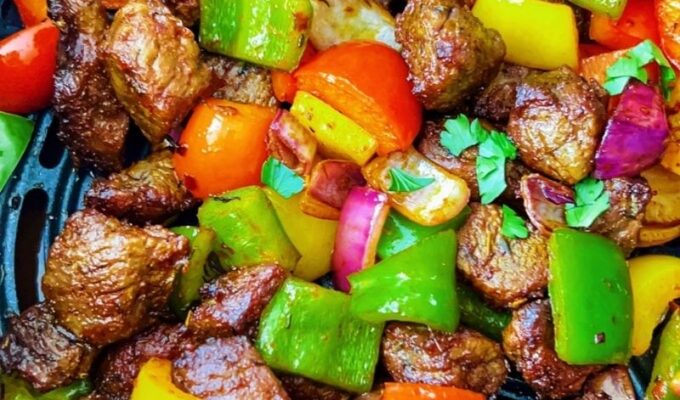 A simple recipe of steak bites in an air fryer with bell peppers, onions, herbs, spices, and cooks in less than 15 minutes is the satisfying pick-me-up dish you want on your table today! Air-fried steak bites and peppers are tasty, flavorful, colorful, scrumptious, crispy, shiny, juicy, and just finger-licking good! These steak bites are equally keto, gluten-free, whole30, and sugar-free. Cooking pepper steak, aka steak bites or beef tips, is easy and comes through quickly in an air fryer. I hope you can give these air fryer steak bites a try! #Steakbites #Steak #Peppersteak #Steakrecipe #beefbites #Beeftips #airfryersteak