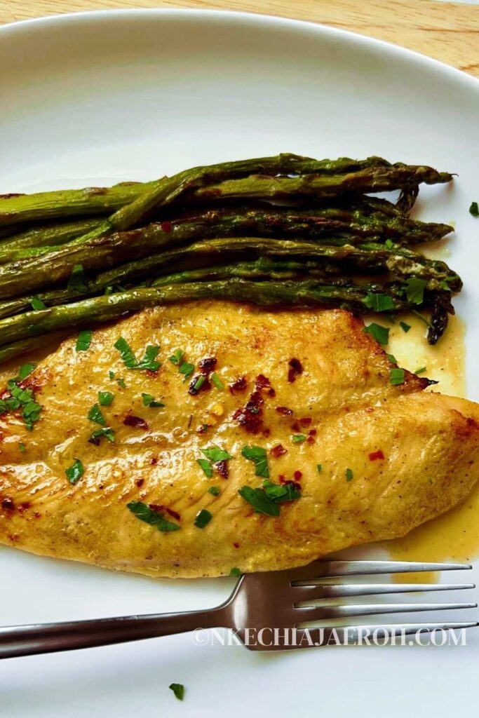 Easy recipe for air fryer swai fish with asparagus combines white-fleshed swai fish, asparagus, and honey mustard marinade. The result is a mouth-watering, flavorful, moist, tasty, juicy, tender fish and vegetable combo that cooks in 15 minutes. Air fried swai fish and asparagus is perfect for a healthy lunch or dinner! Amazingly, air fryer swai fish means that this fish cooks quicker, and cleanup is more effortless. Cooking swai fish in an air fryer equals a moist, juicy, and tasty fish! #swai #swaifish #airfryerswai #airfryerrecipes #airfryerfish #airfryermeal