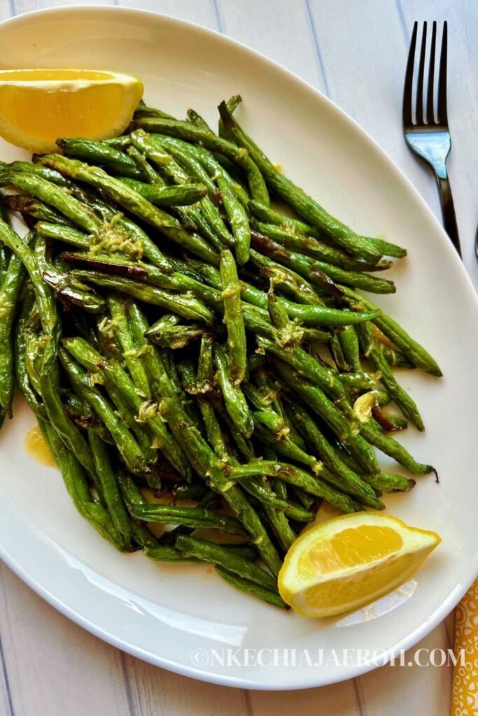 A simple and easy recipe for air fryer green beans with garlic butter sauce requires only a few ingredients; fresh green beans, onions powder, salt, pepper, avocado oil as well a drizzle of garlicky, buttery sauce! Air fried garlic green beans are easy, quick, tender, crisp, deliciously delightful, and perfect with any main dish. P.s. I love it with salmon! This air fryer fried green beans recipe cooks in less than 10 minutes in the air fryer (well, obviously)! But we don't stop there; I take it a little further with my garlic butter sauce. #airfryergreenbeans #greenbeans #garlicsauce #airfryerrecipe 