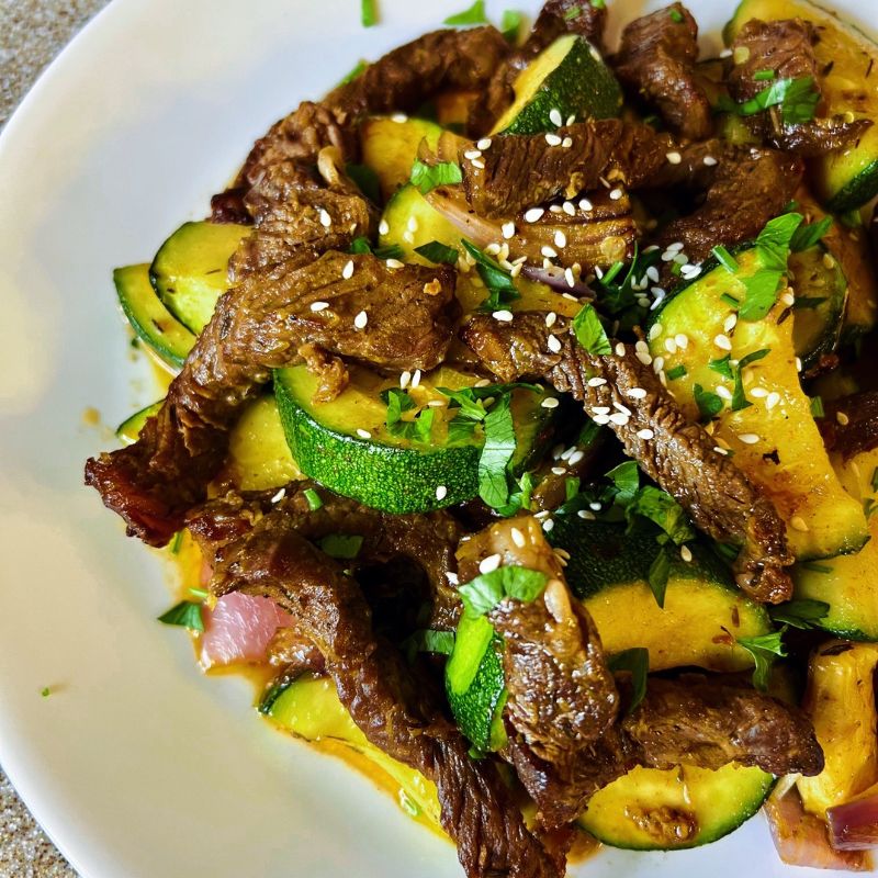 An easy air fryer ribeye steak and zucchini (stir-fry) is a healthy low-carb meal you can easily make in the air fryer. When you air fry a ribeye steak, you end up with a juicy, tasty + satisfying piece of meat. Steak and zucchini stir-fry in the air fryer guarantees you a healthy quick, and easy lunch or dinner. Air-fried ribeye steak and zucchini meal is gluten-free, dairy-free, whole30, low-carb, and keto. #stea #airfryersteak #lowcarb #zucchini #stirfry