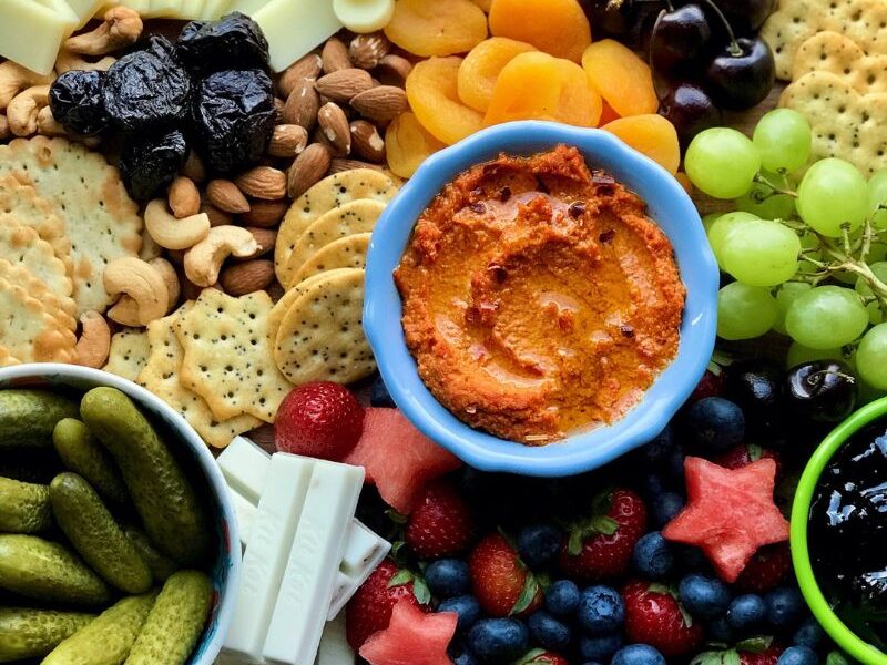 Easy to make healthy charcuterie board is vegetarian (no meat) and more nutritious than most cheese boards. Packed with summer fruits, brined veggies, dried fruits, and nuts, this is the only vegetarian charcuterie board recipe you will ever need! The best thing about a charcuterie board is that it is very customizable, so a charcuterie at BBQs, picnics, parties, and gatherings is a great idea! If you are looking for a 4th of July charcuterie board or summer charcuterie board idea, I got you! This board has the perfect red, white and blue patriotic colors to celebrate American Independence. #charcuterie #healthycharcuterie #Vegetariancharcuterie