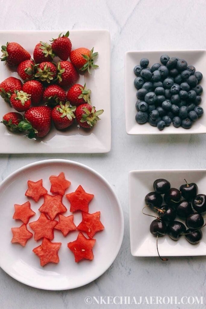 Fresh fruits for a charcuterie - strawberries, blueberries, watermelon, and fresh cherries 