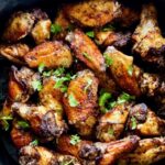 Easy air fryer jerk chicken wings are smoky, spicy, flavorful, and tasty! Crispy on the outside and yet tender and juicy inside. You will be licking every drop of seasoning off your fingers and will never get tired of eating these jerk-seasoned chicken wings. If you are looking for the perfect party dish, these air-fried Jamaican jerk chicken wings are it! #airfryerjerkchicken #jerkchicken #airfriedjerkchicken #chickenwings #jerkmarinade