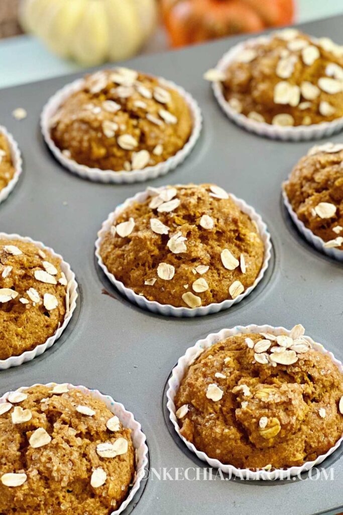 These easy-to-make whole wheat pumpkin muffins with oats are fluffy, moist, pliable, and packed with healthy nutrients! Whole wheat pumpkin muffins require only simple ingredients such as whole wheat flour, oats, pumpkin purée, almond milk, warm fall spices, etc. Perfect fall/autumn season treat your entire family will enjoy. #Pumpkins #Pumpkinmuffins #Fall #Autumn #Pumpkinseason #breakfastmuffin