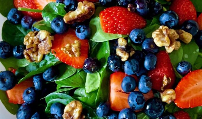 Super healthy and easy-to-make strawberry blueberry spinach salad, aka berry spinach salad with lime olive oil vinaigrette, is loaded with nutritious antioxidants, vitamins, and minerals. Amazingly this spinach and berry salad calls for only a few ingredients - spinach, strawberries, blueberries, walnuts, and a simple lime olive oil vinaigrette! This strawberry blueberry spinach is low-carb, gluten-free, vegan, and easily customizable. #Salad #Spinachsalad #healthysalad #Strawberrysalad #detoxsalad #vegan #lowcarb