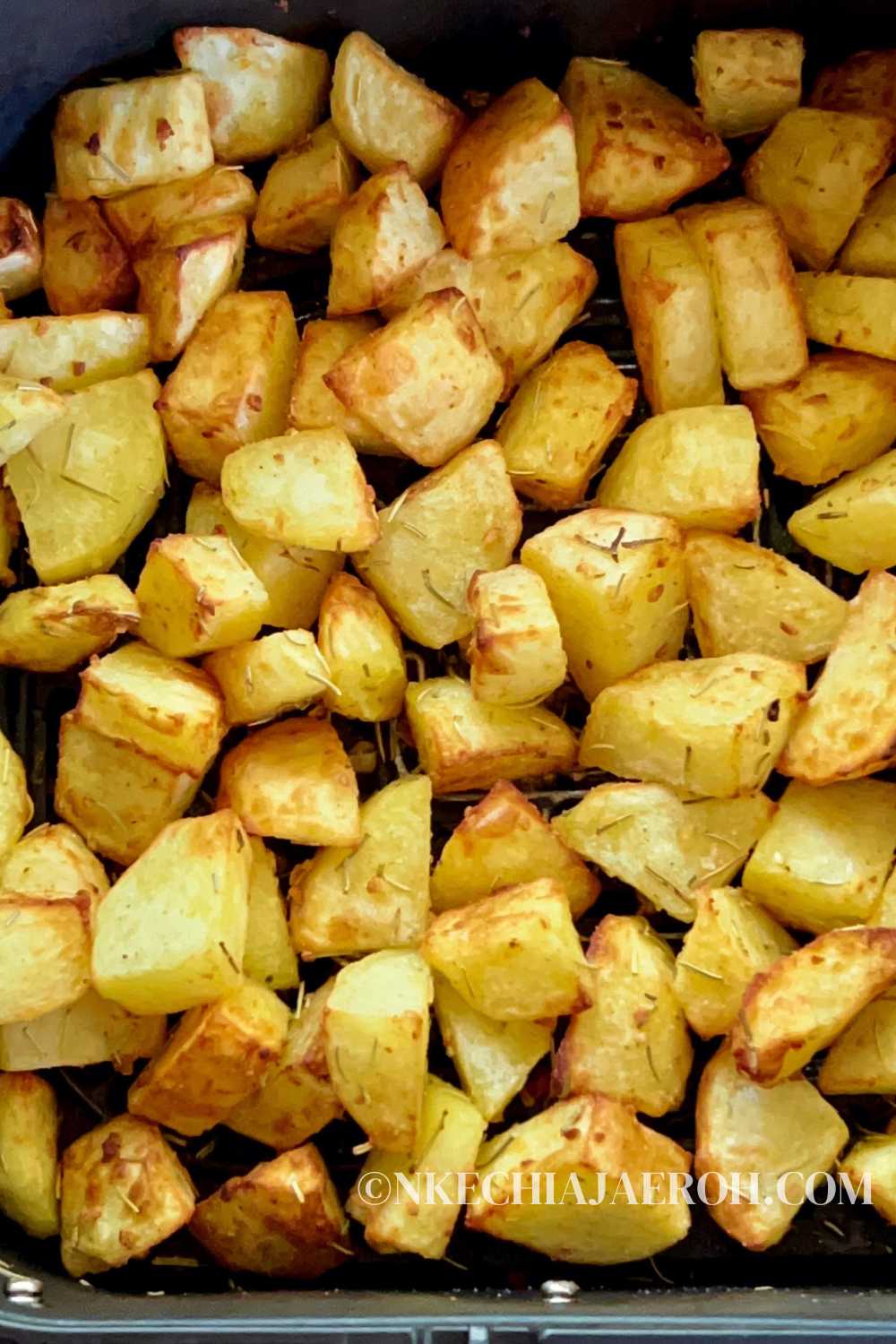 Air fryer roasted potatoes are perfect for the holidays, and the amazing flavors of garlic and rosemary make this dish incredibly flavorful and inviting! These air fryer baked potatoes with rosemary, and garlic are vegan, gluten-free, and super tasty. Crispy cubes of air-fried potatoes with a tender, fluffy center are the side dish you need for any meal. Serve air fryer potato cubes with chicken, lamb, salmon, or steak. #potatoes #easyrecipes #airfryerrecipes