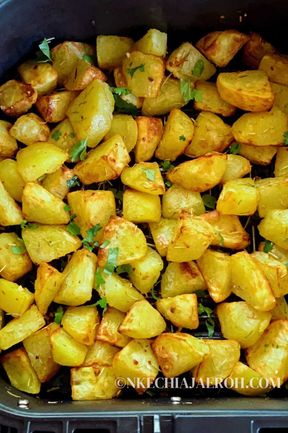 Air fryer roasted potatoes are perfect for the holidays, and the amazing flavors of garlic and rosemary make this dish incredibly flavorful and inviting! These air fryer baked potatoes with rosemary, and garlic are vegan, gluten-free, and super tasty. Crispy cubes of air-fried potatoes with a tender, fluffy center are the side dish you need for any meal. Serve air fryer potato cubes with chicken, lamb, salmon, or steak. #potatoes #easyrecipes #airfryerrecipes