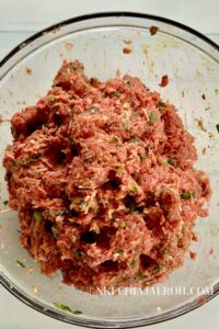 Gently combine the meatball ingredients into a big ball; do not over-mix. However, ensure that everything mixes well.