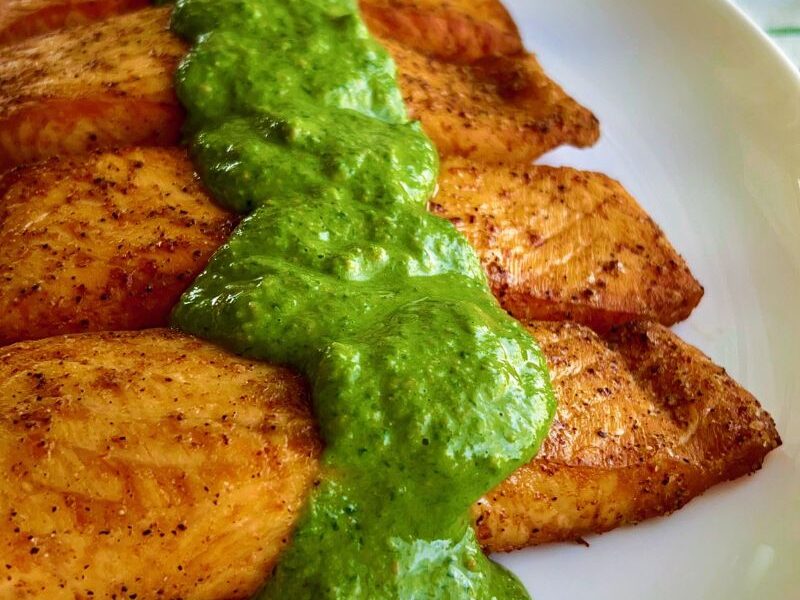 This healthy Salmon recipe is easy to make; it is tasty, gluten-free, low-carb, and perfect for family dinners, hosting, and holidays. Healthy salmon with lime-cashew-spinach green sauce can be cooked in the air fryer or stovetop and will be ready in under 20 minutes. This salmon recipe requires only a few ingredients; salmon, olive oil, and Cajun seasoning. For the green sauce, you will need spinach, cashew, lime, salt, and pepper. #Vegetarianrecipe #fish #salmon #airfryerrecipes
