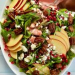 Healthy pomegranate arugula salad with apples and pecans is easy to make, pretty, and perfect for any occasion! My pomegranate salad bursts with delicious flavors from the slightly spiced arugula, sweet and crisp apples, and crunchy pecans. This easy salad is bejeweled with fresh pomegranate seeds or arils and finished with pomegranate salad dressing. This would make an enviable summertime salad recipe as well! #Pomegranatesalad #arugulasalad #pomegranate #salad