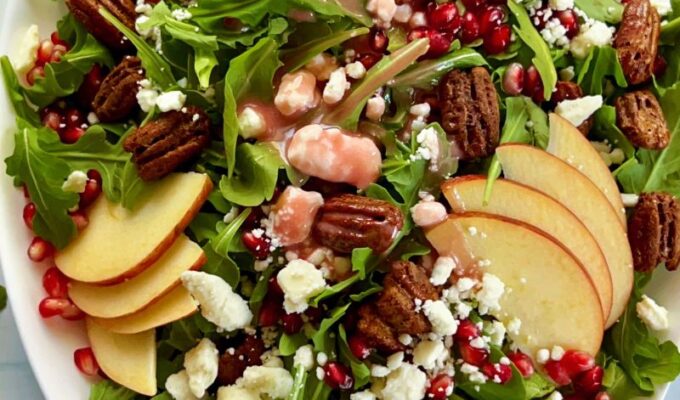 Healthy pomegranate arugula salad with apples and pecans is easy to make, pretty, and perfect for any occasion! My pomegranate salad bursts with delicious flavors from the slightly spiced arugula, sweet and crisp apples, and crunchy pecans. This easy salad is bejeweled with fresh pomegranate seeds or arils and finished with pomegranate salad dressing. This would make an enviable summertime salad recipe as well! #Pomegranatesalad #arugulasalad #pomegranate #salad