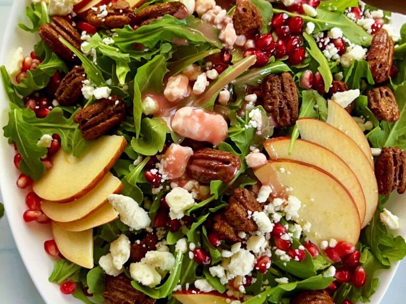 Healthy pomegranate arugula salad with apples and pecans is easy to make, pretty, and perfect for any occasion! My pomegranate salad bursts with delicious flavors from the slightly spiced arugula, sweet and crisp apples, and crunchy pecans. This easy salad is bejeweled with fresh pomegranate seeds or arils and finished with pomegranate salad dressing. This would make an enviable summertime salad recipe as well! #Pomegranatesalad #arugulasalad #pomegranate #salad