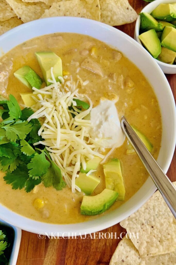 The tastiest creamy, cozy stovetop white chicken chili is the only chili recipe you need for the fall and winter seasons. We are officially in soup season, and this rich white chicken chili will warm your heart and soul! Made with flavorful chicken thighs, hearty cannellini beans, mild green chilies, and whole-kernel corn resulting in a satisfyingly delicious bowl of unforgettable soup. This chili soup is lighter and a great alternative to traditional beef chili! And it makes a perfect dinner for cold, chilly fall and winter nights!