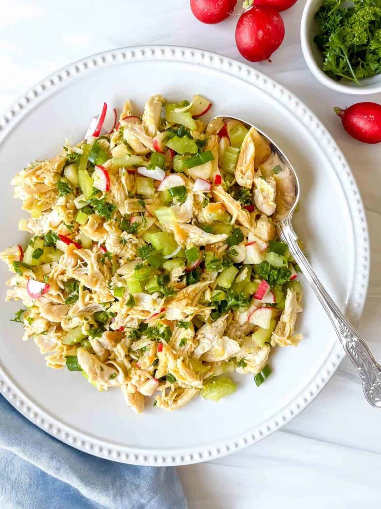 Enjoy this chicken salad without mayo as a tasty summer lunch, BBQ side dish or to take to a potluck! Quick and easy to make in less than 30 minutes, this dairy free chicken salad is packed with healthy vegetables, herbs and has a lightly spiced olive oil based dressing that's so delicious!