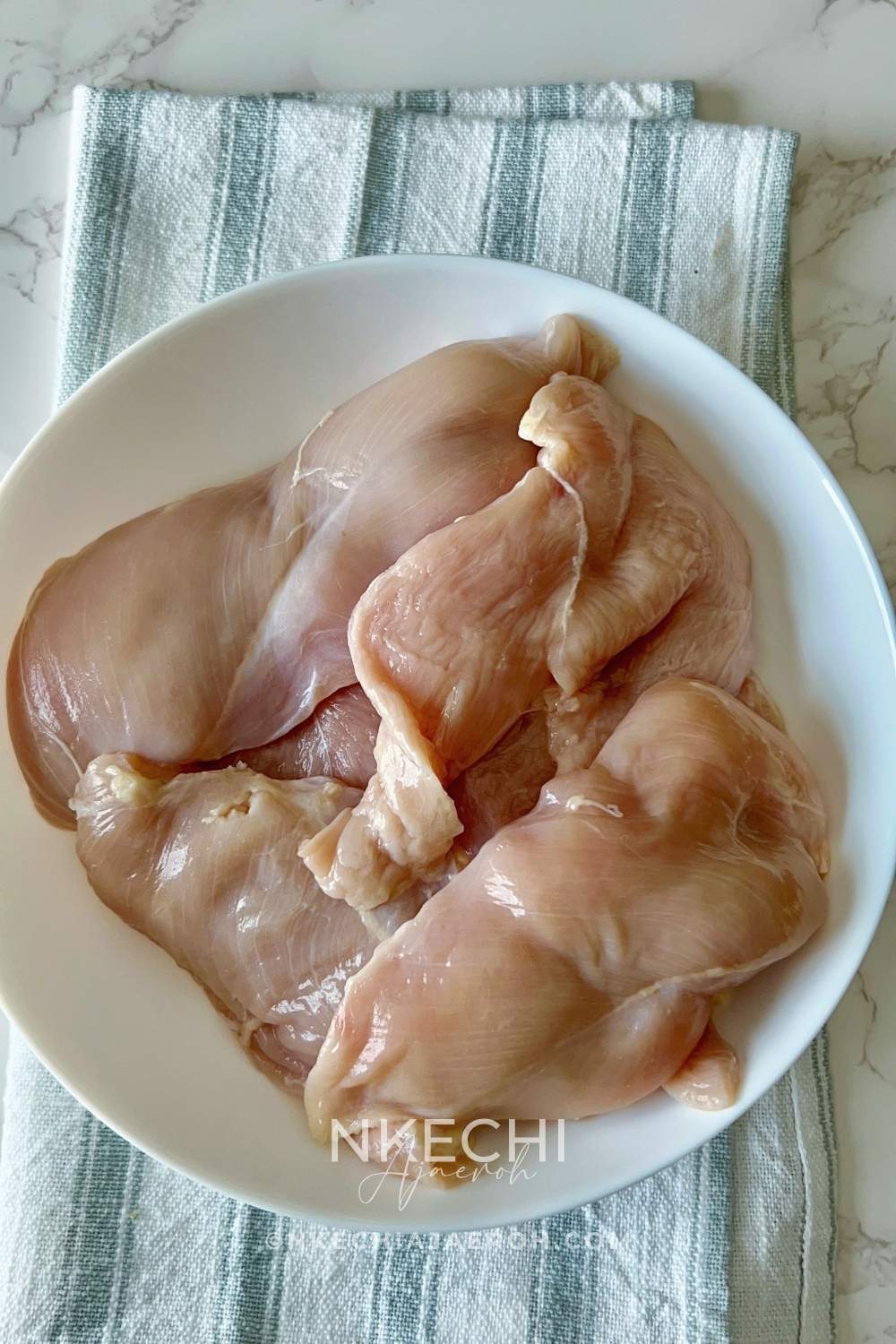 Clean/prep the Chicken. Wash and clean your chicken as needed (skip this step if you don't wash your chicken). Pat dry your chicken with a paper towel to ensure it isn't wet. Slice your chicken breast into halves.