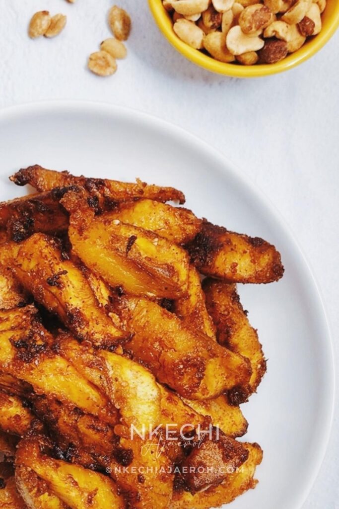 Kelewele or Aloco (Alloco) is a Ghanaian spiced fried plantain recipe. This richly flavored fried snack is very popular in the streets of Ghana and typically pairs with groundnuts (peanuts). The combination of sweet, ripe plantains with fresh herbs and spices such as fresh onions, ginger, and other dry traditional spices makes this dish unique and unforgettable. If you like fried plantains, you will love these Ghanaian spicy fried plantains - kelewele. What does Kelewele  (Ghanaian Spicy Fried Plantains) Taste Like? What does Kelewele mean? In English, kelewele means “hot plantain crisps.” It is simply a spicy or spiced fried ripe plantains. These Ghanaian spicy fried plantains are gluten-free, dairy-free, and vegan.