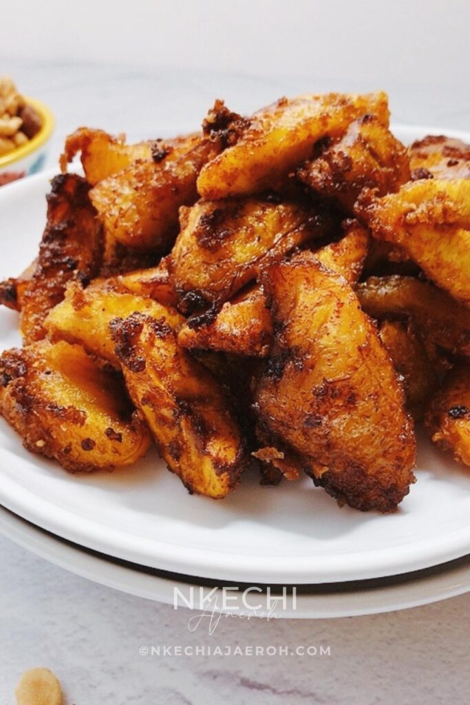 Kelewele or Aloco (Alloco) is a Ghanaian spiced fried plantain recipe. This richly flavored fried snack is very popular in the streets of Ghana and typically pairs with groundnuts (peanuts). The combination of sweet, ripe plantains with fresh herbs and spices such as fresh onions, ginger, and other dry traditional spices makes this dish unique and unforgettable. If you like fried plantains, you will love these Ghanaian spicy fried plantains - kelewele. What does Kelewele  (Ghanaian Spicy Fried Plantains) Taste Like? What does Kelewele mean? In English, kelewele means “hot plantain crisps.” It is simply a spicy or spiced fried ripe plantains. These Ghanaian spicy fried plantains are gluten-free, dairy-free, and vegan.