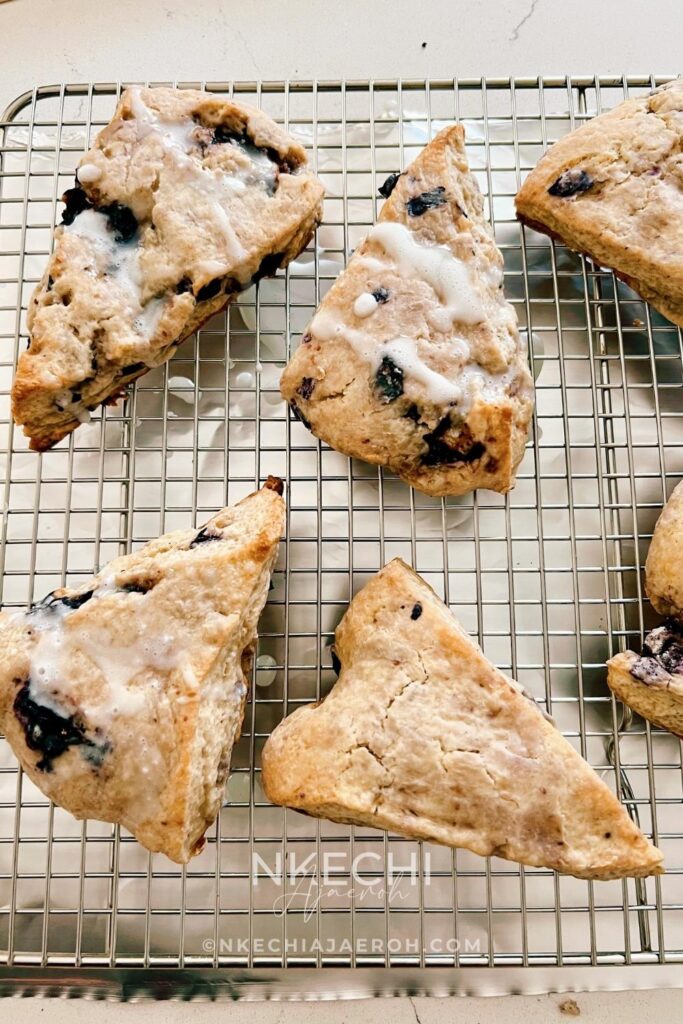 There are scones, and then there are these super sweet + nutritious blueberry scones made with frozen ripe blueberries. Wishing you could just eat those blueberry scones you saw at the bakery? Let me show you how to make your own with the sweetest and most nutritious blueberry scones recipe EVER! Made with frozen berries, you won’t have to wait for berry season to enjoy these. If you have ever had a scone before you know that you typically smash butter, cream, or fruit sauce or preserve on them but not this one! These melt-in-your-mouth blueberry scones are super sweet, rich, and decadent, and no extra accompaniment is needed.