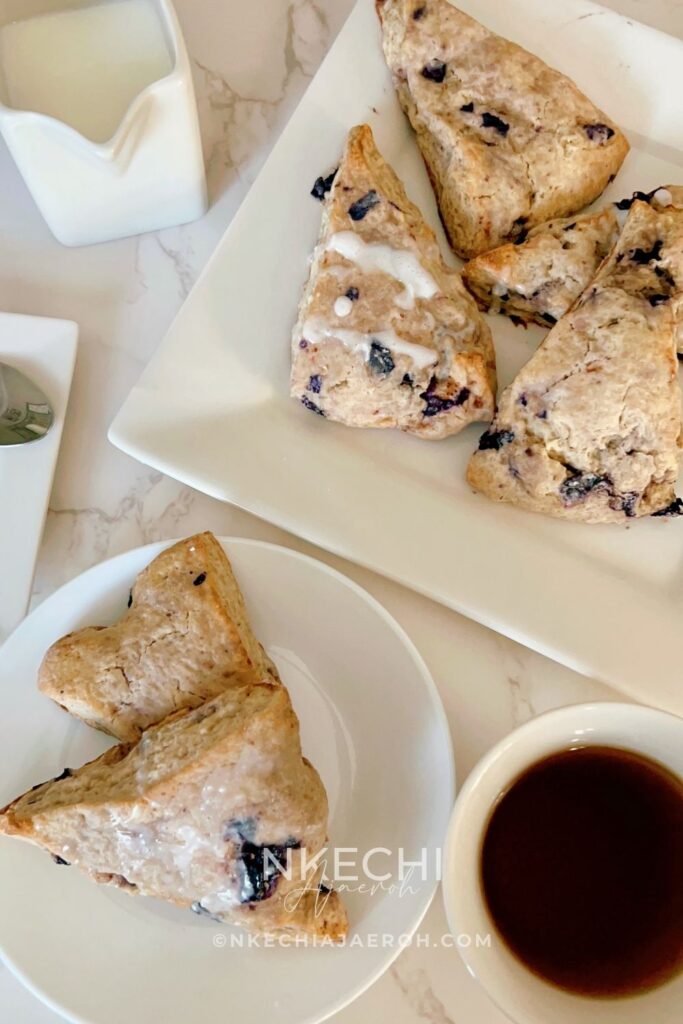 There are scones, and then there are these super sweet + nutritious blueberry scones made with frozen ripe blueberries. Wishing you could just eat those blueberry scones you saw at the bakery? Let me show you how to make your own with the sweetest and most nutritious blueberry scones recipe EVER! Made with frozen berries, you won’t have to wait for berry season to enjoy these. If you have ever had a scone before you know that you typically smash butter, cream, or fruit sauce or preserve on them but not this one! These melt-in-your-mouth blueberry scones are super sweet, rich, and decadent, and no extra accompaniment is needed.