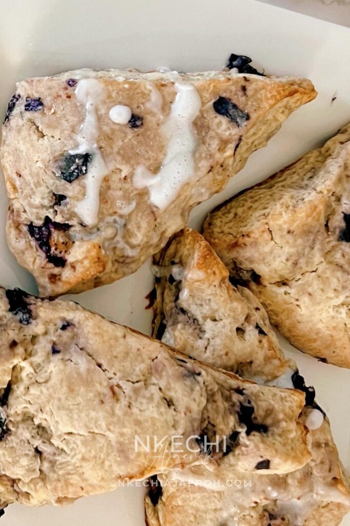 There are scones, and then there are these super sweet + nutritious blueberry scones made with frozen ripe blueberries. Wishing you could just eat those blueberry scones you saw at the bakery? Let me show you how to make your own with the sweetest and most nutritious blueberry scones recipe EVER! Made with frozen berries, you won’t have to wait for berry season to enjoy these. If you have ever had a scone before you know that you typically smash butter, cream, or fruit sauce or preserve on them but not this one! These melt-in-your-mouth blueberry scones are super sweet, rich, and decadent, and no extra accompaniment is needed. Perfect for breakfast, brunch, or just as dessert.