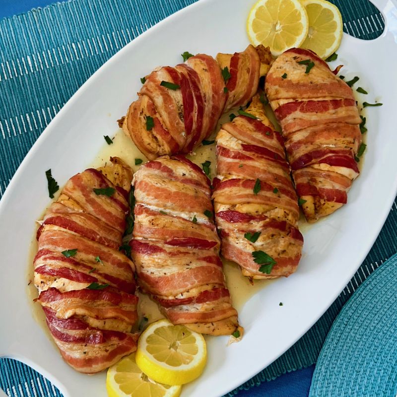 Here is how to make the most delectable oven-baked bacon wrapped chicken breasts recipe without brown sugar. This juicy and nutritious chicken recipe is easy, tasty, and such a crowd-pleaser! Bacon-Wrapped Chicken Breasts is kid-friendly as most kids love everything bacon! The ingredients for oven-baked bacon wrapped chicken breasts are simple. First of all, the chicken is well seasoned and then wrapped with bacon, protecting them from over-drying. In the end, you are left with juicy, tasty chicken breast that you can serve with any side dish.
