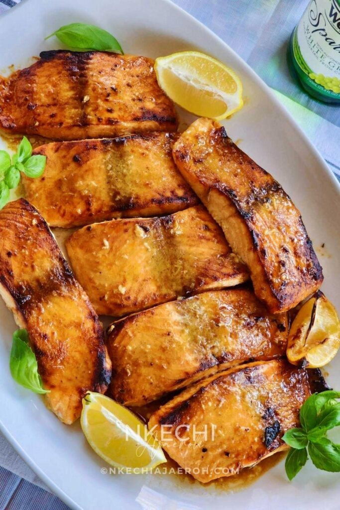 This simple oven-baked buttery honey mustard salmon recipe is first seasoned with the honey mustard sauce and then baked to perfection. These salmon is tasty, flaky, buttery and not to mention that they are super easy to make and requires no expertise!
I have several salmon recipes here on the blog including, air fryer salmon and pan seared salmon. However, these oven-baked buttery honey mustard salmon is our favorite. The butter, honey and mustard using in making this recipe makes it unique. These will be your favorite too! This oven-baked salmon recipe is ideal for meal prepping and can be versatile and great for special occasions.