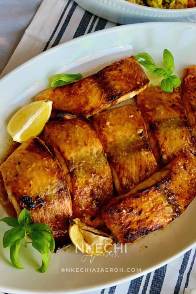 This simple oven-baked buttery honey mustard salmon recipe is first seasoned with the honey mustard sauce and then baked to perfection. These salmon is tasty, flaky, buttery and not to mention that they are super easy to make and requires no expertise!
I have several salmon recipes here on the blog including, air fryer salmon and pan seared salmon. However, these oven-baked buttery honey mustard salmon is our favorite. The butter, honey and mustard using in making this recipe makes it unique. These will be your favorite too! This oven-baked salmon recipe is ideal for meal prepping and can be versatile and great for special occasions.