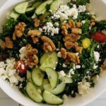 The only easy kale salad you need! This kale feta salad recipe is packed with walnuts, cucumbers, and tomatoes. If you love kale, then you will enjoy this healthy salad, but if you are skeptical about kale, then this will change your mind. Though this is a vegetarian salad, you can still add meat or fish of your choice to make it more filling. This salad comes together in minutes, and if you know you need to eat more veggies but are tired of the same old stuff, this one is going to make you love salad. It’s such a rewarding bowl of goodness, and I’m here to help you get it on your table tonight! What are the ingredients in kale salad? Can you eat raw kale as a salad? What's in Chick-fil-A's kale salad? How do you get the bitterness out of kale salad?