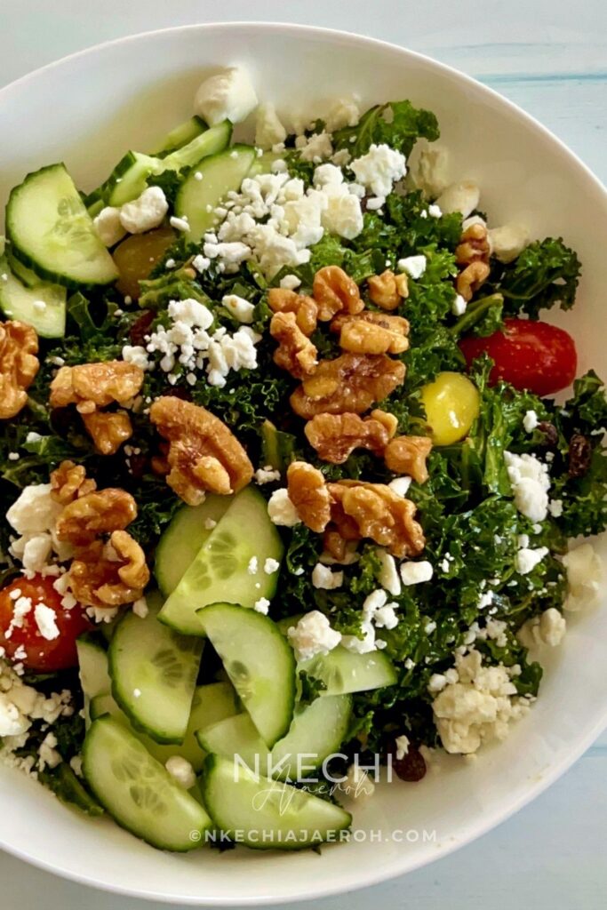 The only easy kale salad you need! This kale feta salad recipe is packed with walnuts, cucumbers, and tomatoes. If you love kale, then you will enjoy this healthy salad, but if you are skeptical about kale, then this will change your mind. Though this is a vegetarian salad, you can still add meat or fish of your choice to make it more filling. This salad comes together in minutes, and if you know you need to eat more veggies but are tired of the same old stuff, this one is going to make you love salad. It’s such a rewarding bowl of goodness, and I’m here to help you get it on your table tonight! What are the ingredients in kale salad? Can you eat raw kale as a salad? What's in Chick-fil-A's kale salad? How do you get the bitterness out of kale salad?