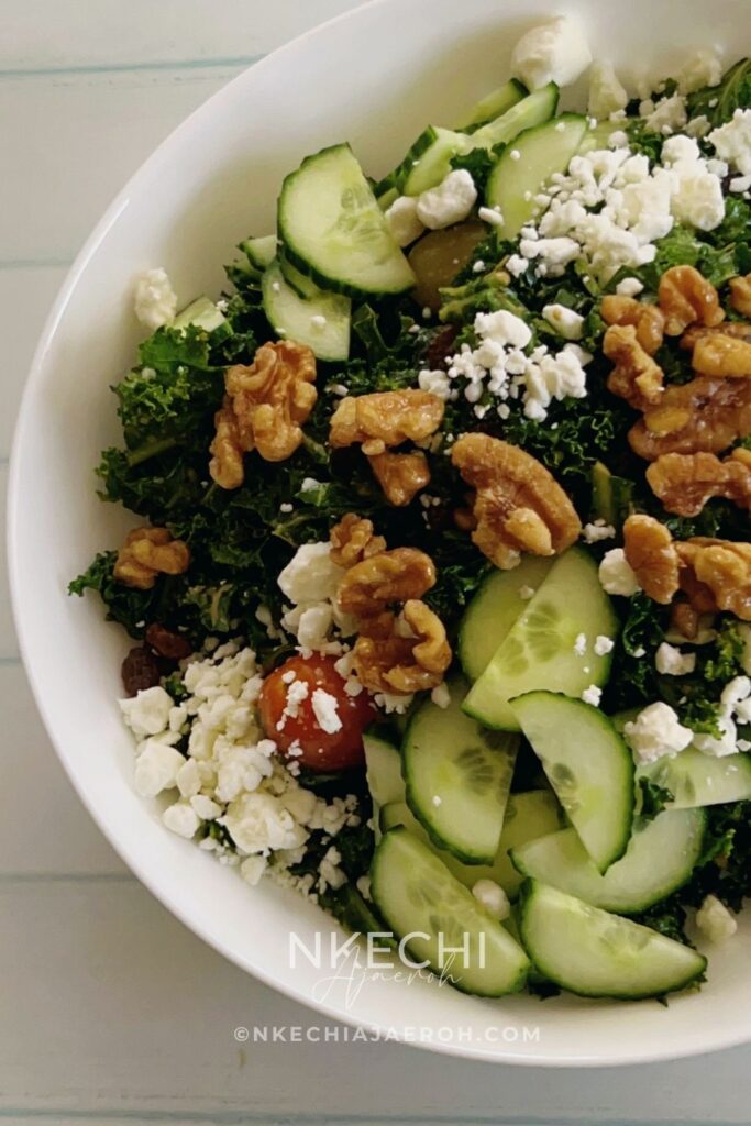 The only easy kale salad you need! This kale feta salad recipe is packed with walnuts, cucumbers, and tomatoes. If you love kale, then you will enjoy this healthy salad, but if you are skeptical about kale, then this will change your mind. Though this is a vegetarian salad, you can still add meat or fish of your choice to make it more filling. This salad comes together in minutes, and if you know you need to eat more veggies but are tired of the same old stuff, this one is going to make you love salad. It’s such a rewarding bowl of goodness, and I’m here to help you get it on your table tonight! What are the ingredients in kale salad? Can you eat raw kale as a salad? What's in Chick-fil-A's kale salad? How do you get the bitterness out of kale salad?