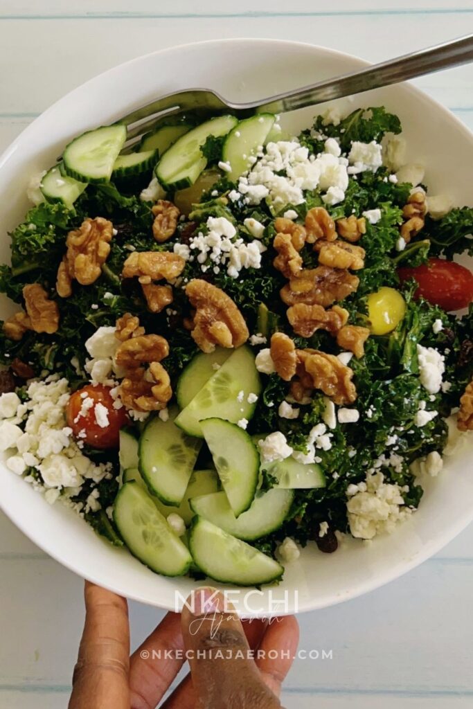 The only easy kale salad you need! This kale feta salad recipe is packed with crunchy kale leaves, toasted walnuts, feta cheese, cucumbers, and tomatoes. If you love kale, then you will enjoy this healthy salad, but if you are skeptical about kale, then this will change your mind. Though this is a vegetarian salad, you can still add meat or fish of your choice to make it more filling. This salad comes together in minutes, and if you know you need to eat more veggies but are tired of the same old stuff, this one is going to make you love salad. Itโs such a rewarding bowl of goodness, and Iโm here to help you get it on your table tonight! What are the ingredients in kale salad? Can you eat raw kale as a salad? What's in Chick-fil-A's kale salad? How do you get the bitterness out of kale salad?