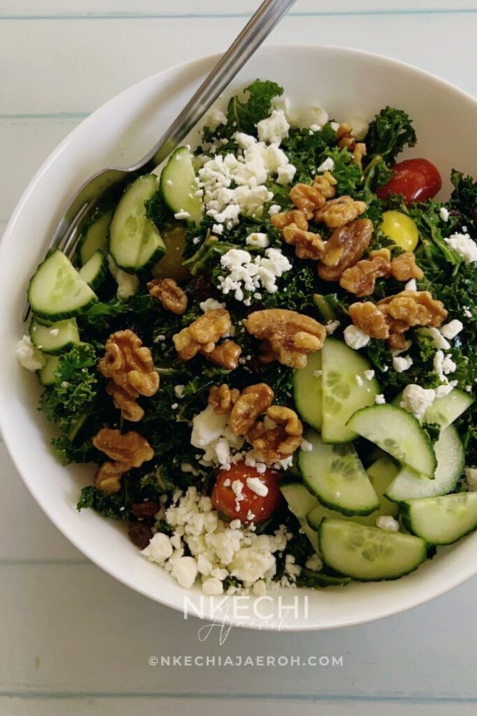 The only easy kale salad you need! This kale feta salad recipe is packed with crunchy kale leaves, toasted walnuts, feta cheese, cucumbers, and tomatoes. If you love kale, then you will enjoy this healthy salad, but if you are skeptical about kale, then this will change your mind. Though this is a vegetarian salad, you can still add meat or fish of your choice to make it more filling. This salad comes together in minutes, and if you know you need to eat more veggies but are tired of the same old stuff, this one is going to make you love salad. It’s such a rewarding bowl of goodness, and I’m here to help you get it on your table tonight! What are the ingredients in kale salad?