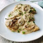 Can we take a moment to rave about this flavorful, finger-licking, good, and satisfyingly delicious creamy mushroom chicken breast recipe? This chicken dinner recipe is a win-win situation. Packed with nutritious ingredients and smothered in creamy, garlicky sauce. This is one restaurant-quality food you and your family will enjoy. It is a versatile recipe that is perfect for Sunday dinner, holidays, and still easy for weeknight meals. Need to break free from the same old dinner rotation items? Turn your chicken dinner into a culinary masterpiece with my creamy garlic mushroom chicken breast recipe. Easy enough for any night of the week, yet delicious enough for Sunday dinners and entertaining your guests.